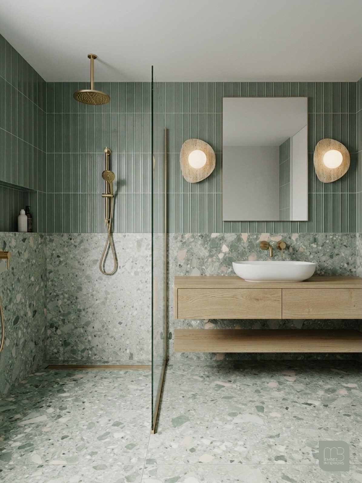 Green terrazzo flooring and walls in a modern bathroom with wooden vanity.
