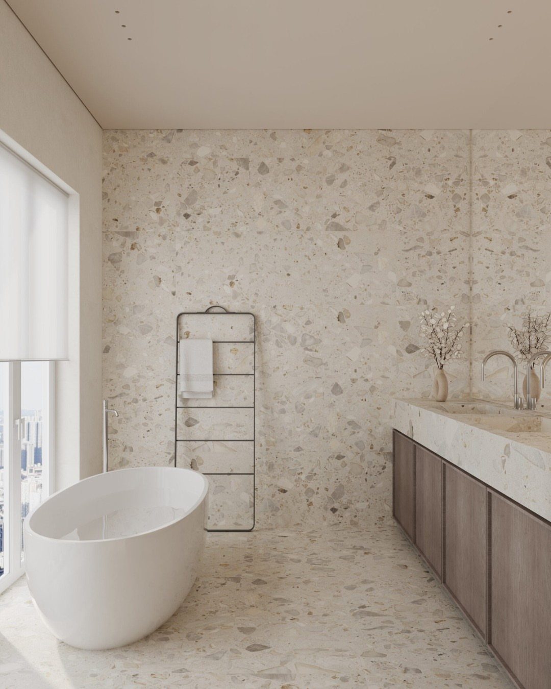 Modern bathroom with large light terrazzo tiles, white bathtub, and wooden vanity.