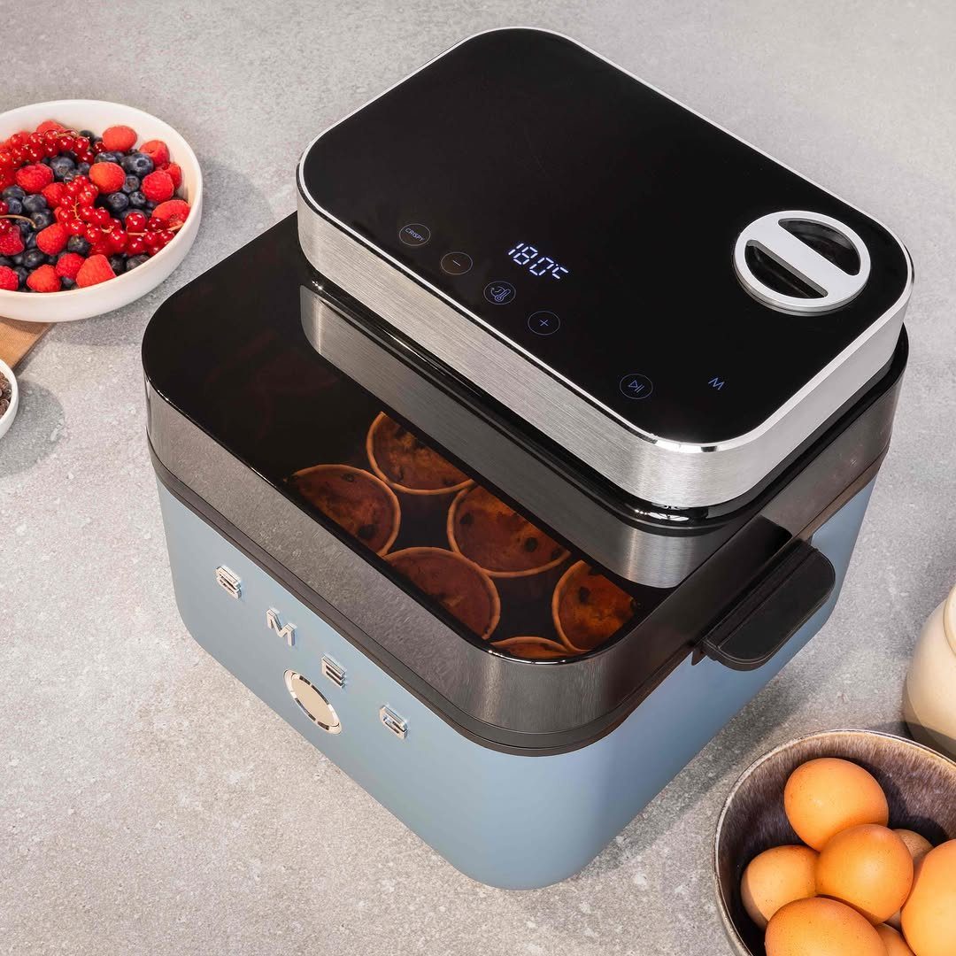 Blue Kitchen Appliances: 28 Ideas from Ranges to Kettles 7 Light blue air fryer with cookies inside on a grey kitchen countertop.