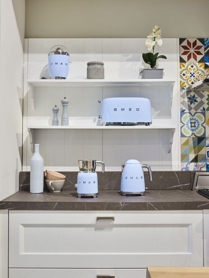 Blue Kitchen Appliances: 28 Ideas from Ranges to Kettles 27 Light blue Smeg toaster, kettle, and espresso machine on white kitchen shelves.
