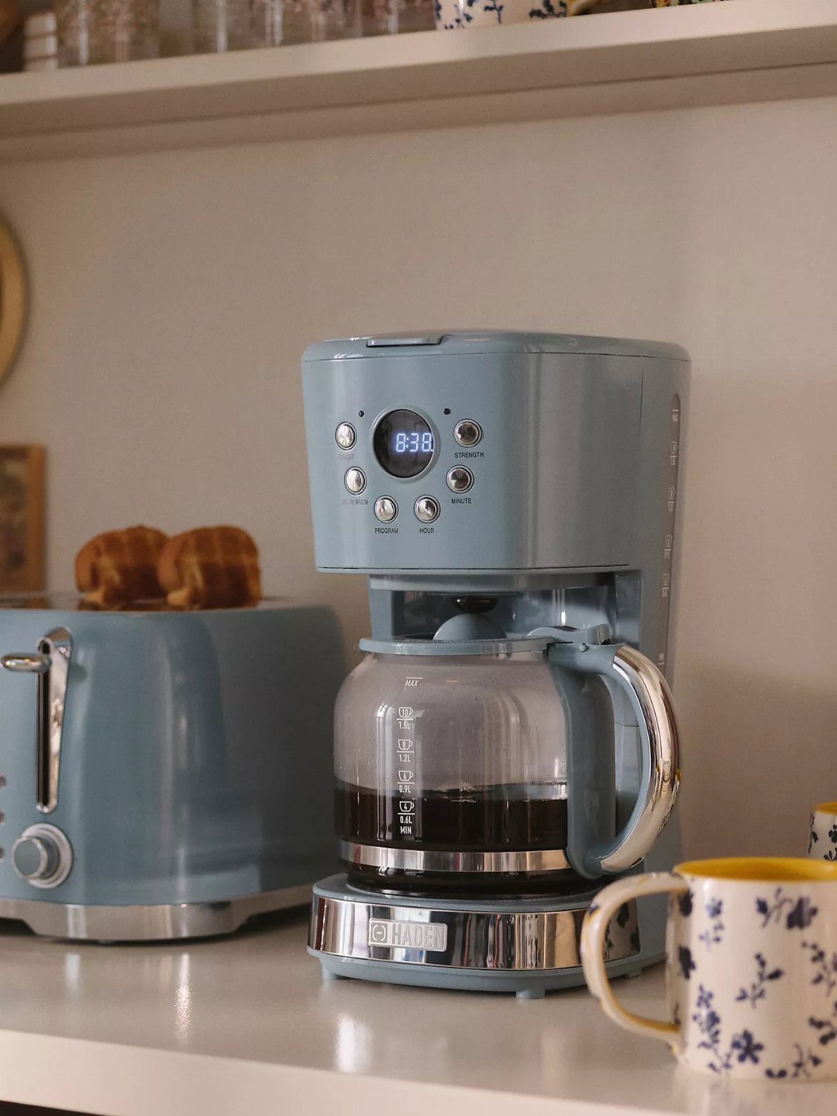Blue Kitchen Appliances: 28 Ideas from Ranges to Kettles 11 Light blue drip coffee maker with a glass carafe on a white kitchen counter.