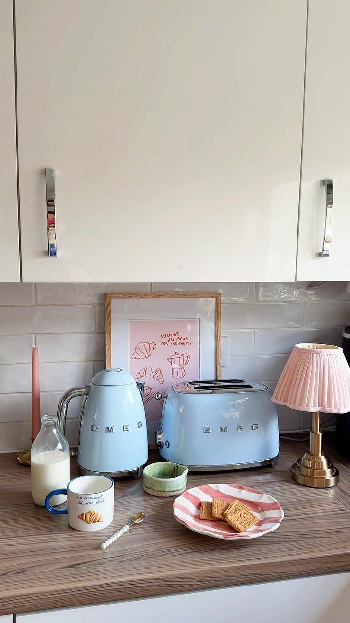 Blue Kitchen Appliances: 28 Ideas from Ranges to Kettles 23 Light blue Smeg kettle and toaster on a wooden kitchen counter with breakfast items.