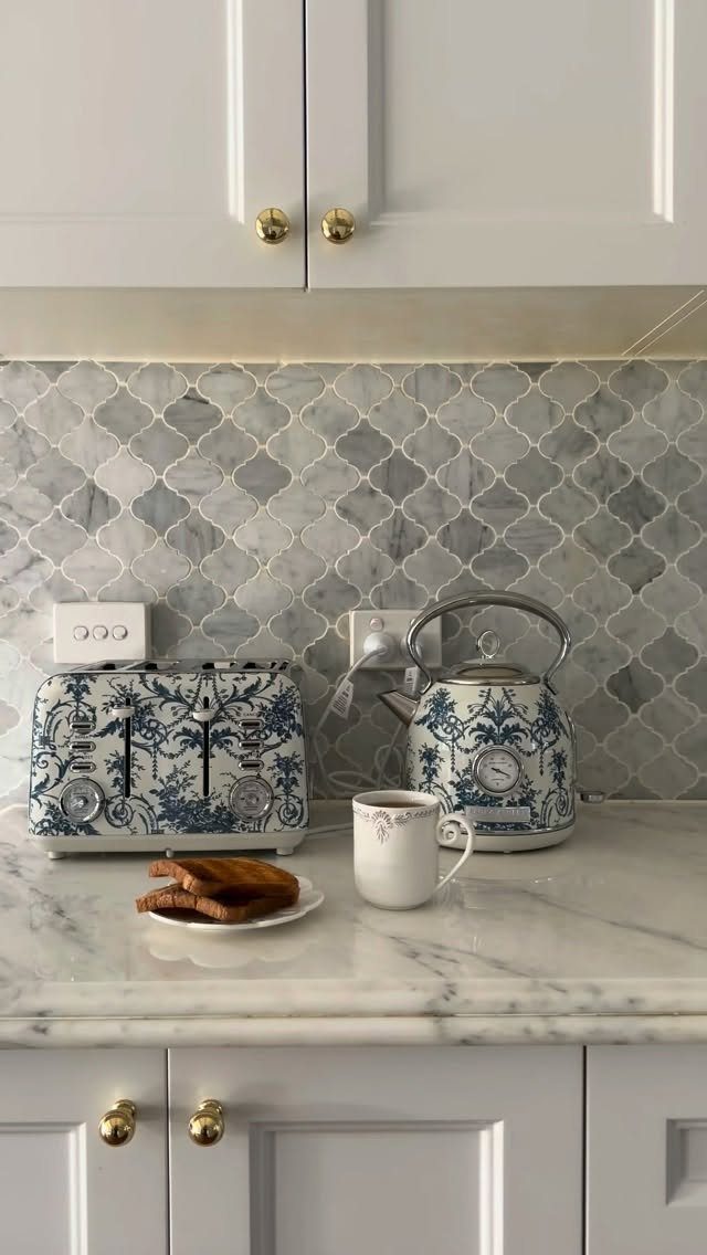 Blue Kitchen Appliances: 28 Ideas from Ranges to Kettles 9 Blue and white patterned toaster and kettle on a white marble kitchen counter.