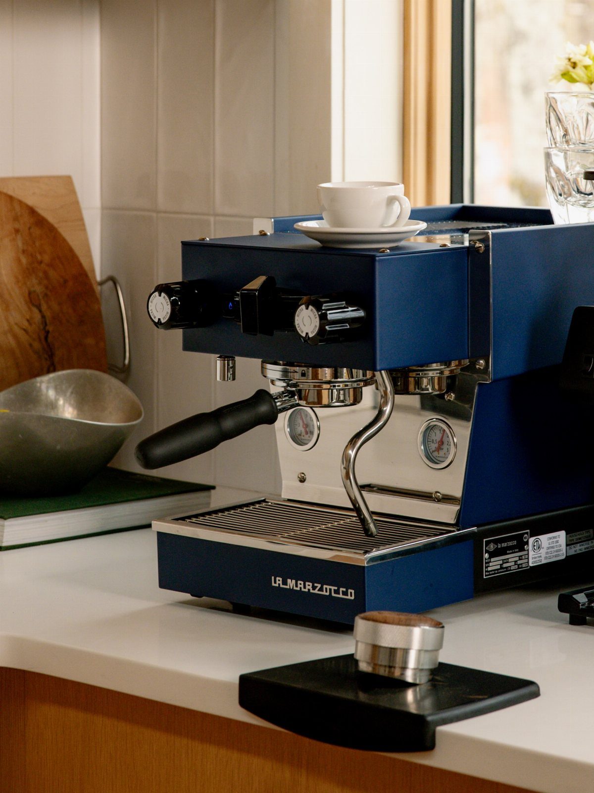 Blue Kitchen Appliances: 28 Ideas from Ranges to Kettles 10 Dark blue espresso machine with a white coffee cup on a white countertop.