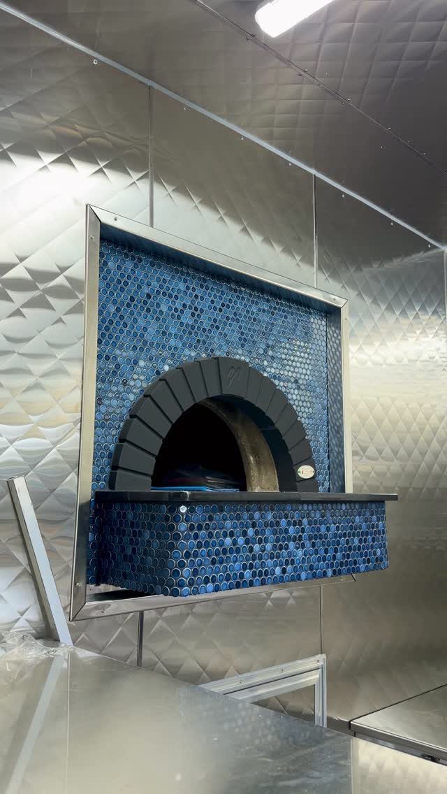 Blue Kitchen Appliances: 28 Ideas from Ranges to Kettles 17 Blue mosaic tile pizza oven with a black arch in a metallic kitchen.