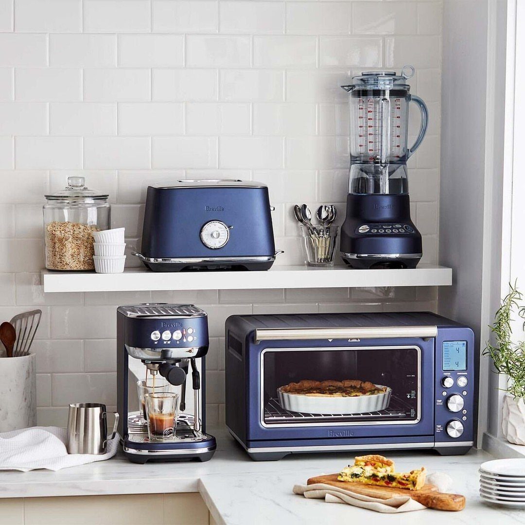 Blue Kitchen Appliances: 28 Ideas from Ranges to Kettles 15 Dark blue kitchen appliances on a white countertop against white subway tile walls.