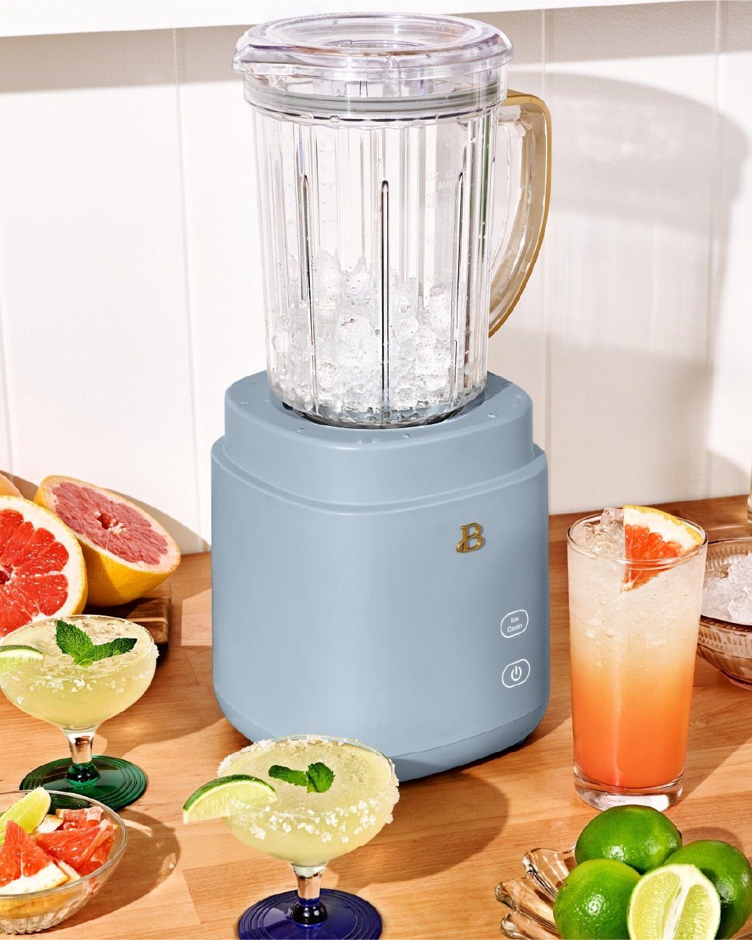 Blue Kitchen Appliances: 28 Ideas from Ranges to Kettles 24 Light blue blender with ice surrounded by cocktails and citrus fruits on wooden counter