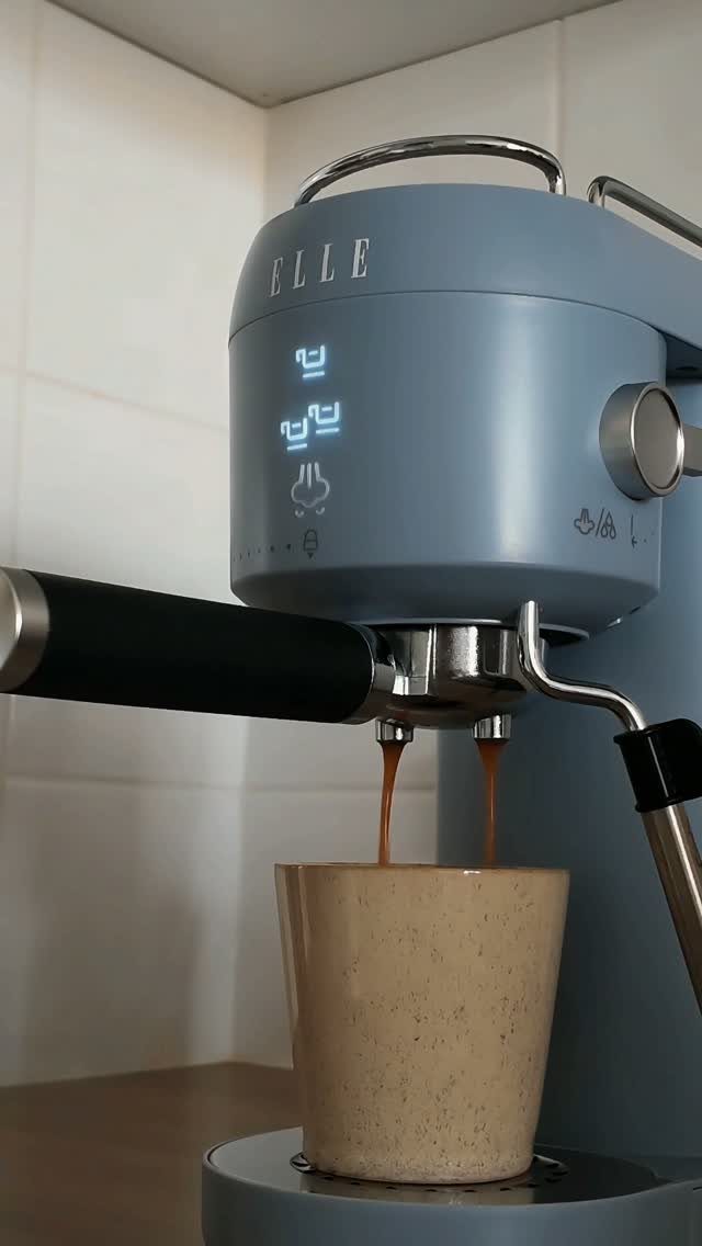 Blue Kitchen Appliances: 28 Ideas from Ranges to Kettles 25 Light blue espresso machine pouring coffee into a beige speckled ceramic cup.