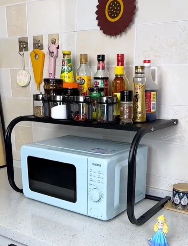 Blue Kitchen Appliances: 28 Ideas from Ranges to Kettles 20 Light blue microwave oven on a white countertop under a black spice rack.