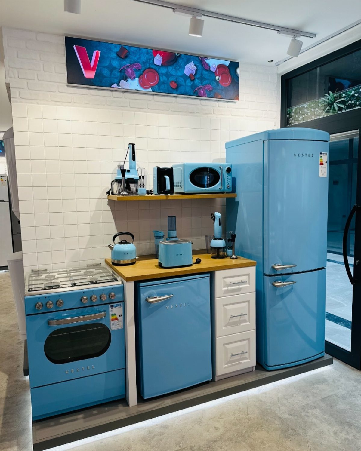 Blue Kitchen Appliances: 28 Ideas from Ranges to Kettles 13 Light blue kitchen appliances including a refrigerator, oven, and microwave in a showroom.