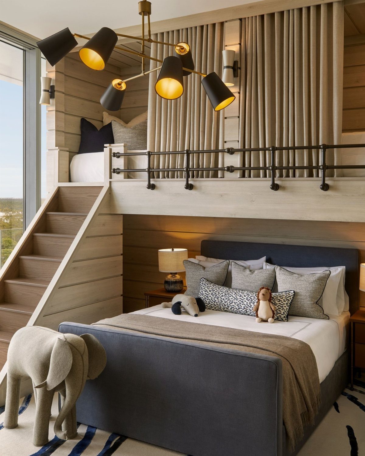 Built-in bunk beds with beige curtains and a navy blue lower bed