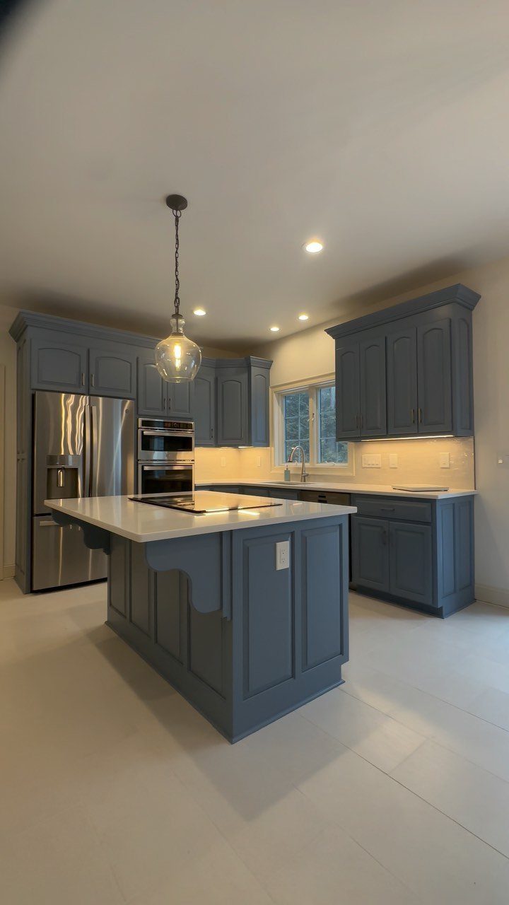 Cabinet Color Trends: 11 Ideas for Your Kitchen in 2026 4 Blue kitchen cabinets with a white island and stainless steel appliances.
