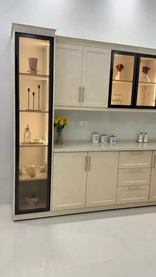 Cabinet Color Trends: 11 Ideas for Your Kitchen in 2026 12 Creamy white kitchen cabinets with gold hardware and a glass display shelf.