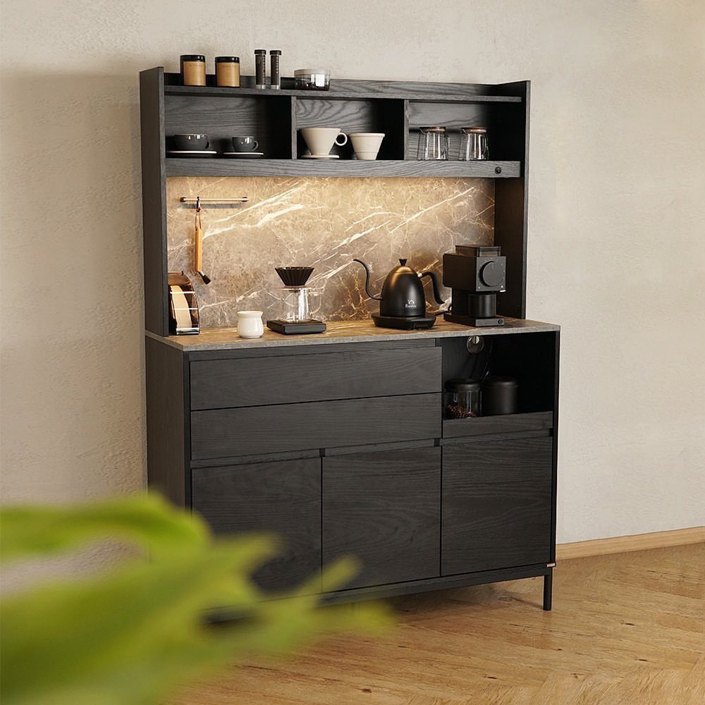 Dark wood coffee bar cabinet with marble backsplash and brewing equipment on top.