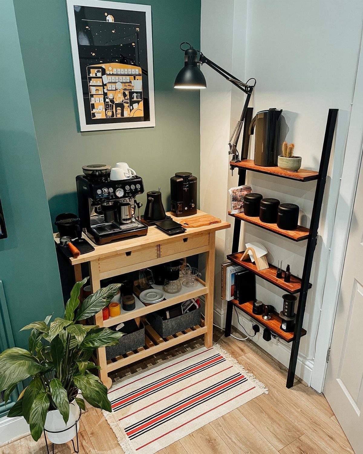 Wooden coffee cart with espresso machine and accessories next to a ladder shelf.