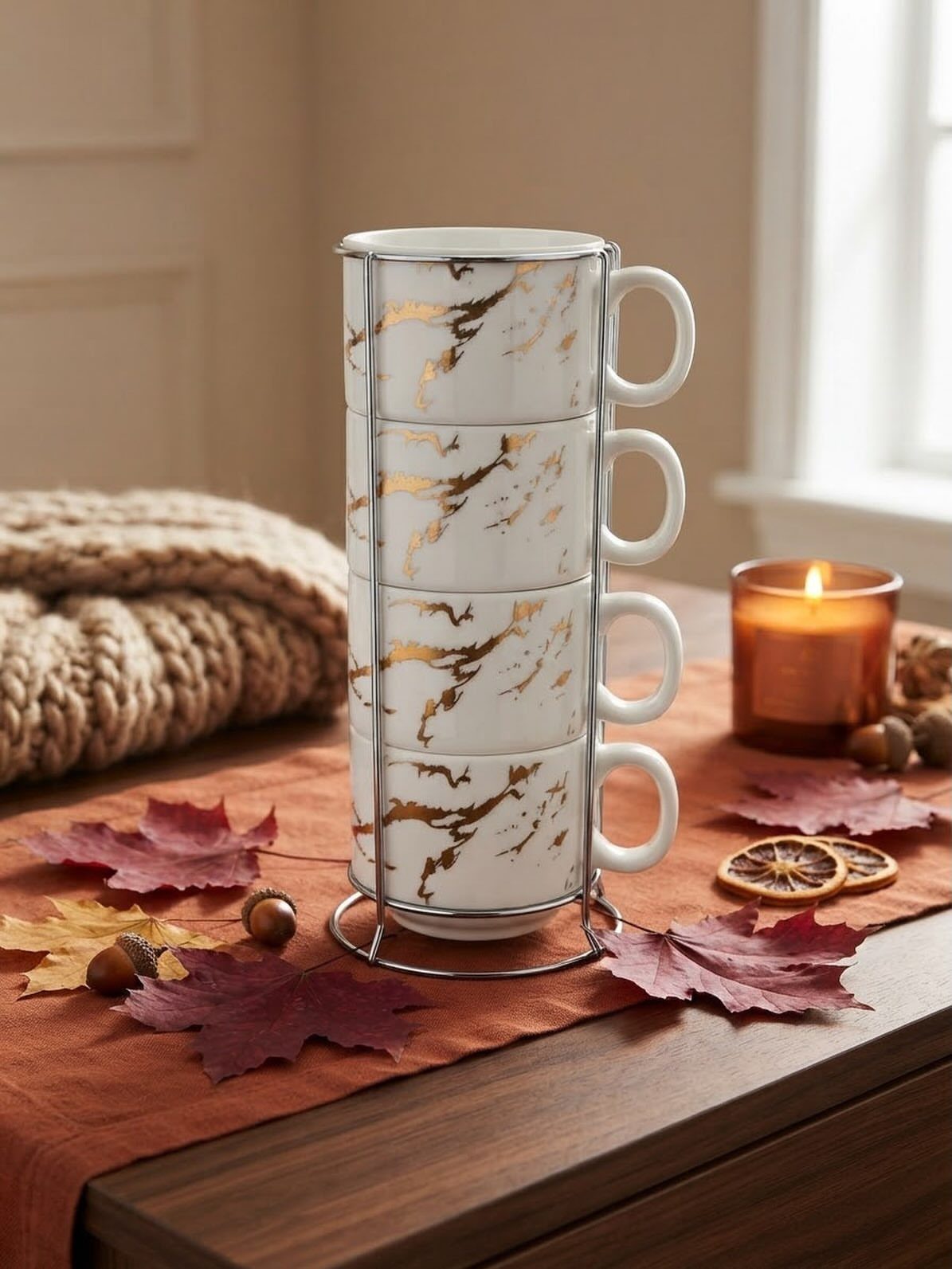 Four gold marble patterned mugs stacked in a silver metal wire rack.