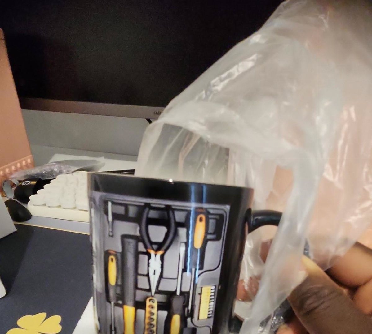 Black ceramic mug with a realistic 3D print of a toolbox and tools.