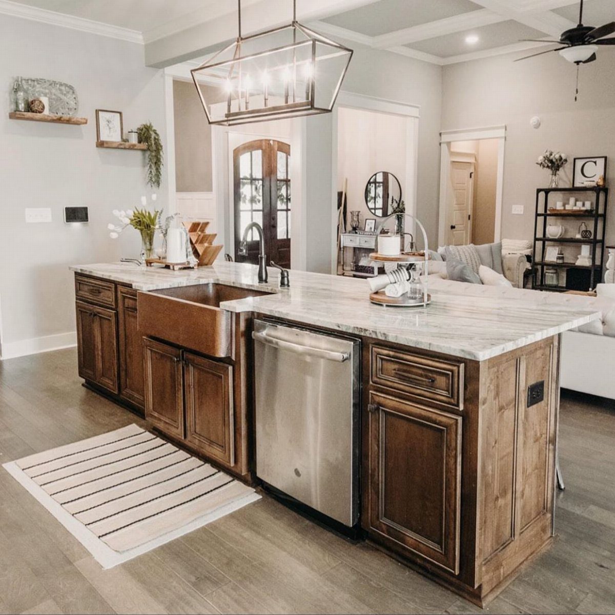 Farmhouse Kitchen Island Ideas: 14 Styles with Photos 13 Copper farmhouse sink installed in a dark wood kitchen island with marble countertops.