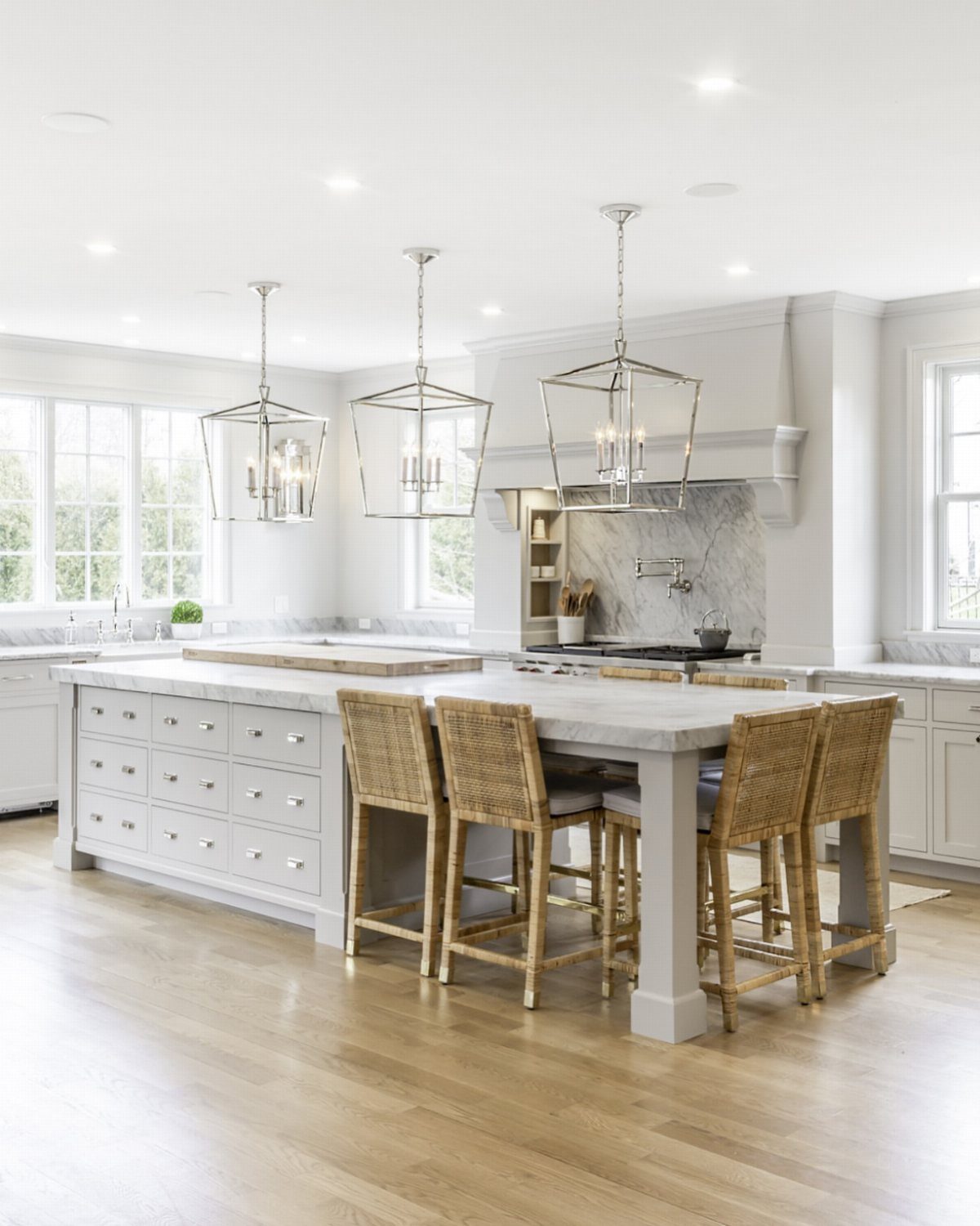 Farmhouse Kitchen Island Ideas: 14 Styles with Photos 3 Light gray kitchen island with stone countertop and three woven wicker bar stools.