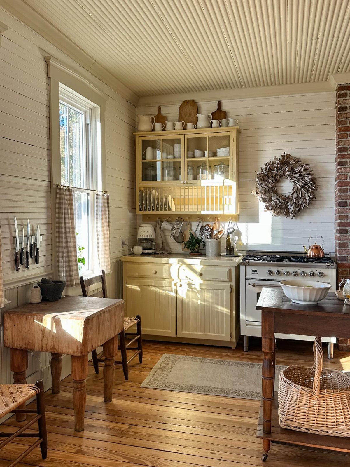 Farmhouse Kitchen Island Ideas: 14 Styles with Photos 4 Rustic kitchen featuring a repurposed dark wood worktable used as a kitchen island.