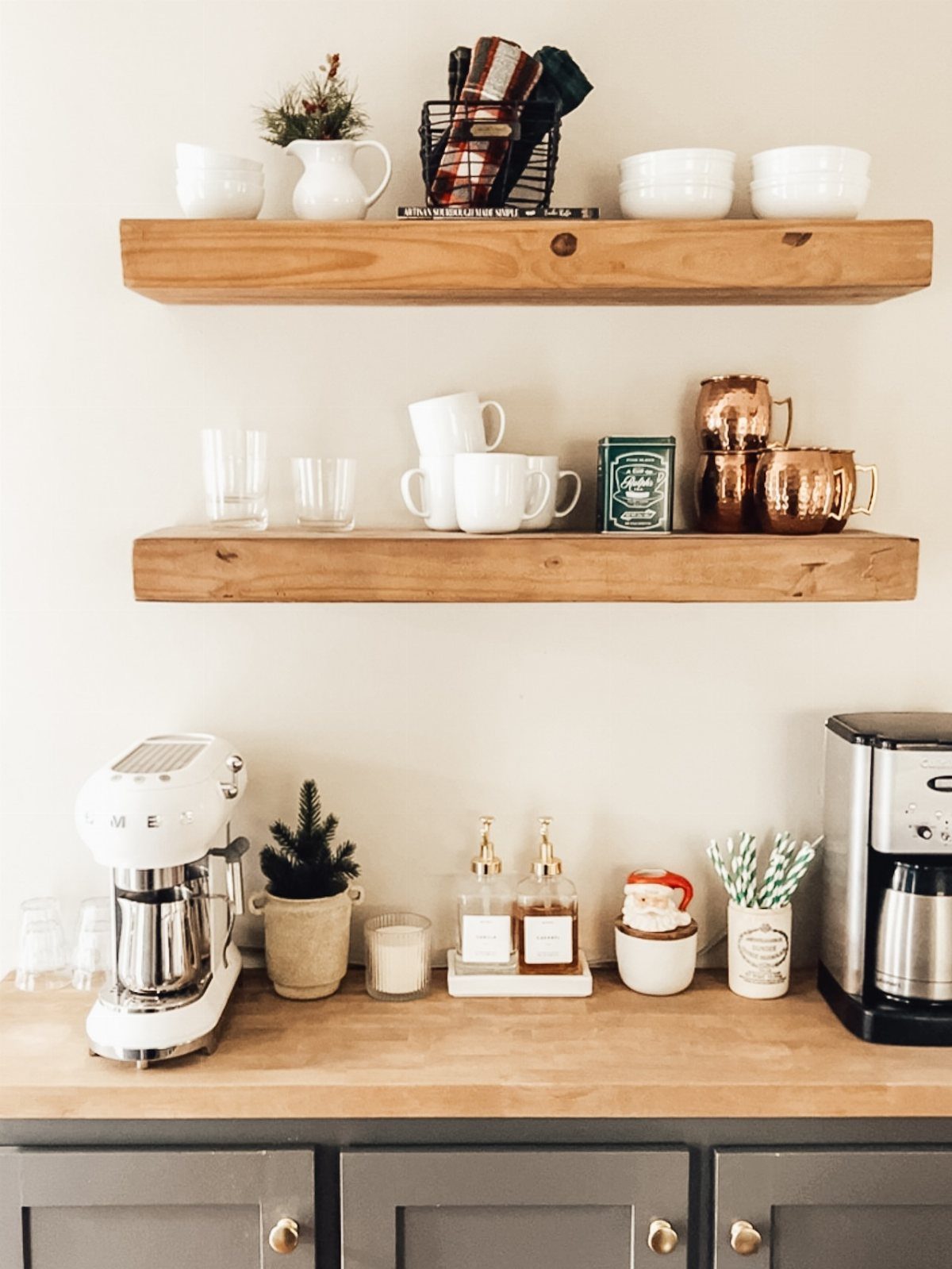 16 Home Coffee Stand Ideas to Fit Any Space 12 Home coffee station with wooden shelves, espresso machine, and winter holiday decorations.