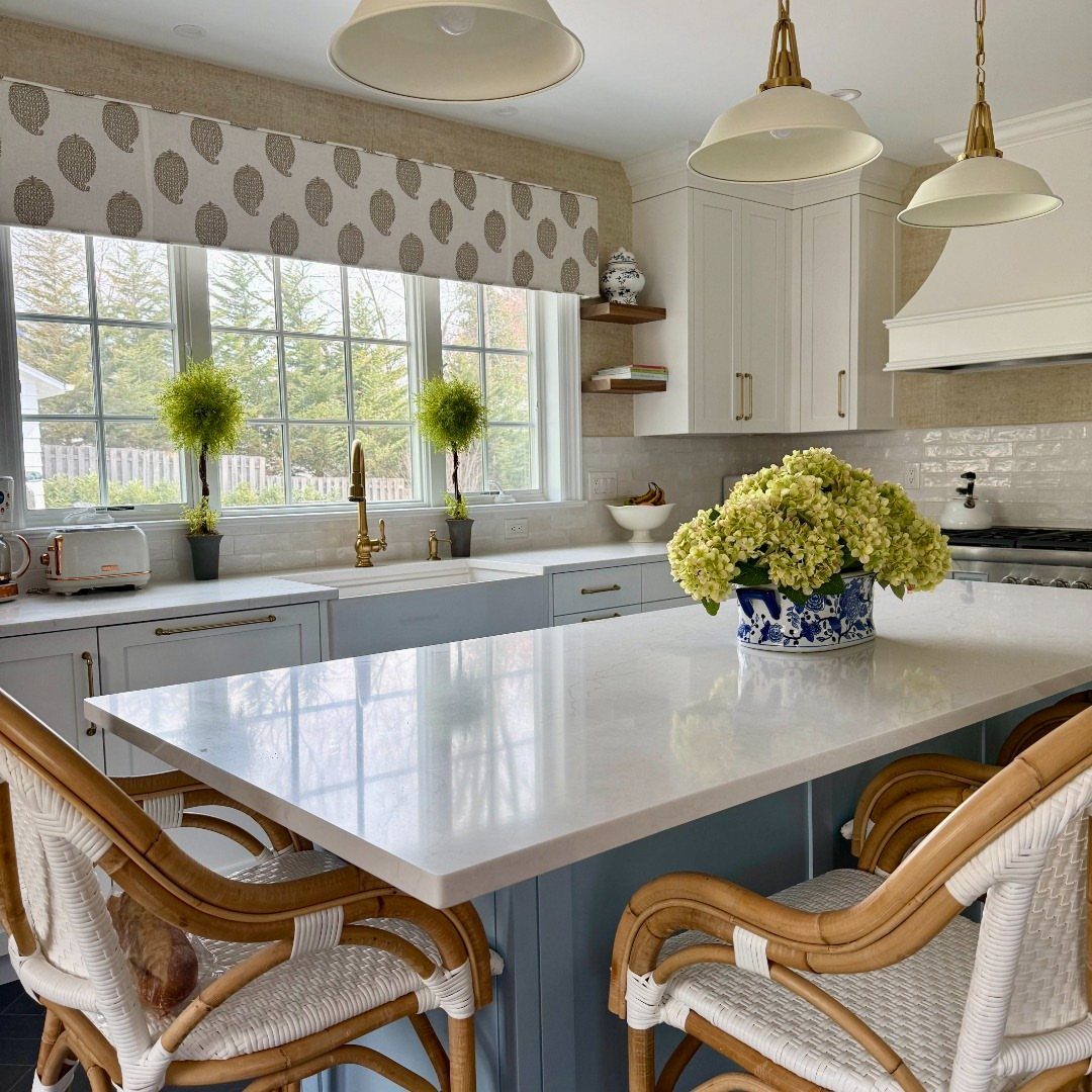 20 Home Kitchen Decor Ideas to Refresh Your Space 10 Kitchen island with blue cabinets and a patterned fabric window valance above sink.