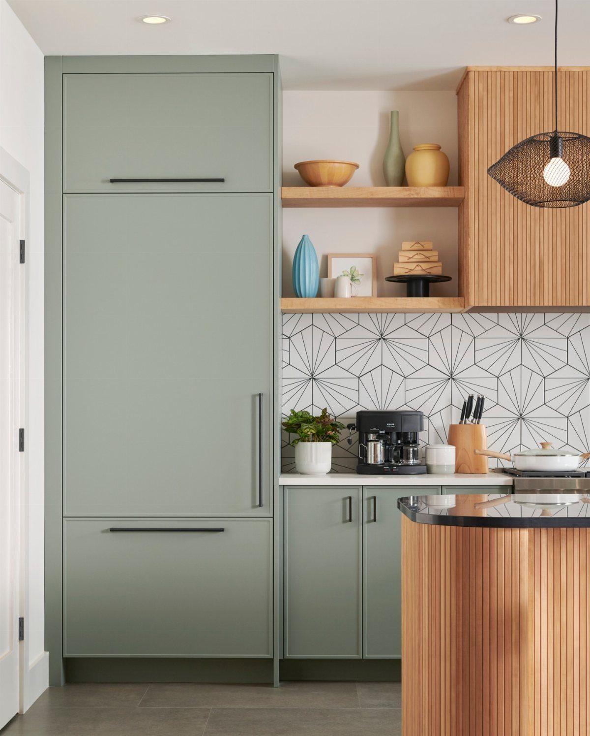 20 Home Kitchen Decor Ideas to Refresh Your Space 16 Sage green kitchen cabinets with a black and white geometric tile backsplash.