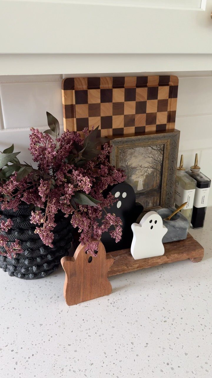 20 Home Kitchen Decor Ideas to Refresh Your Space 12 Woven basket with purple flowers and wooden decor on a white kitchen countertop.
