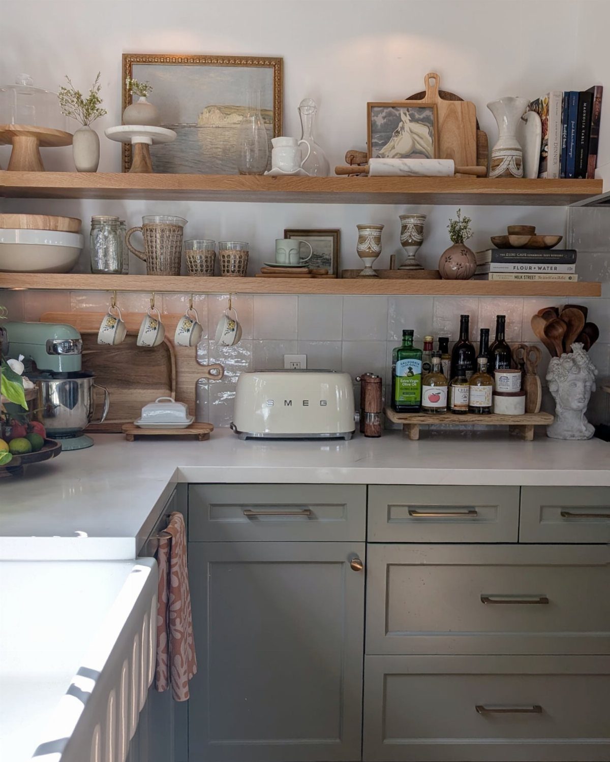 20 Home Kitchen Decor Ideas to Refresh Your Space 2 Wooden open shelves holding dishes and decor above grey kitchen cabinets and white countertop