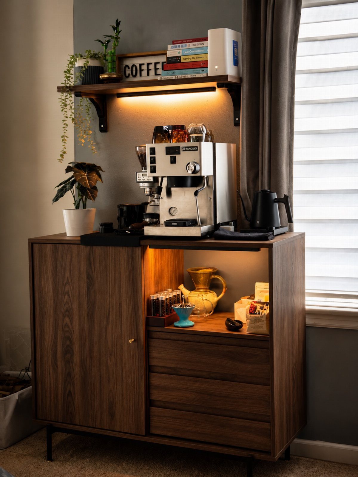 Dark wood coffee cabinet with espresso machine and illuminated floating shelf above.