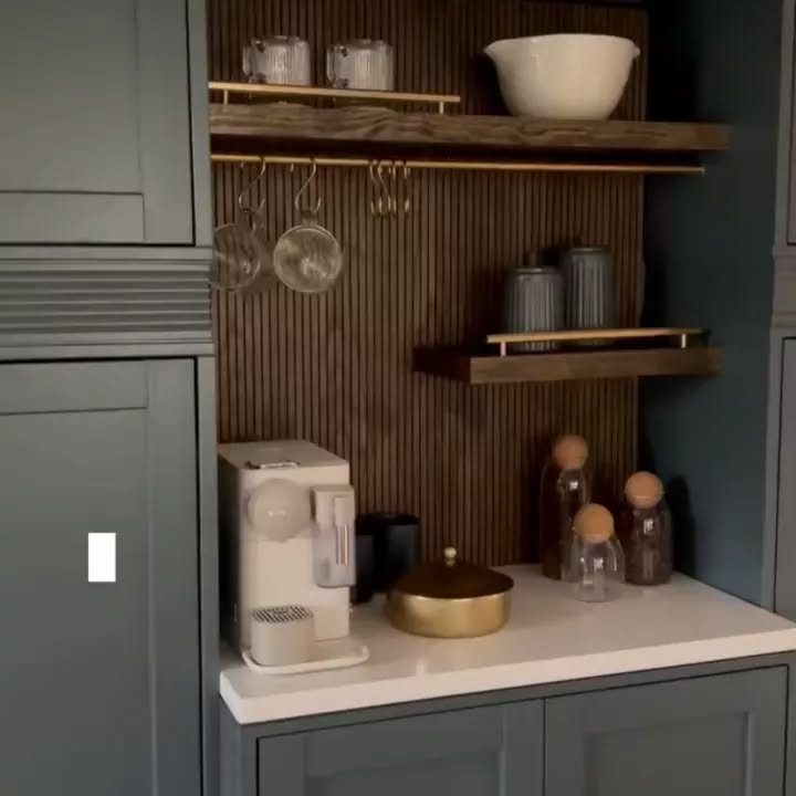 Grey shaker coffee nook with slatted wood backsplash and gold shelving accents