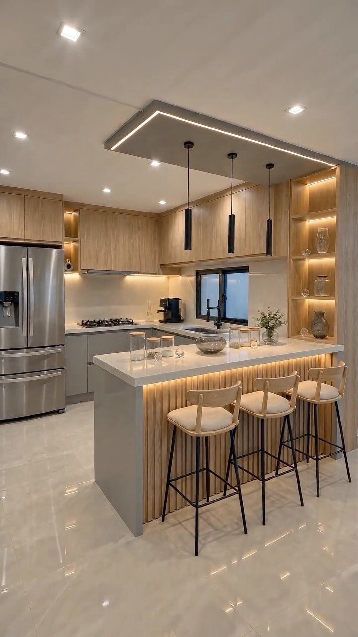 Modern kitchen island with white countertop and three high-backed bar stools for seating.