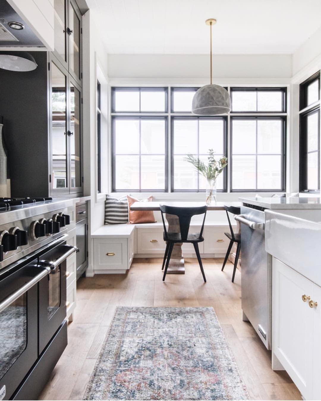 Patterned blue and grey area rug on a light wood kitchen floor.