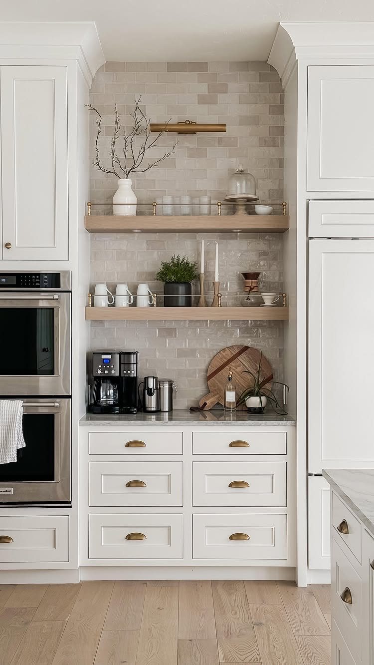 Two light-wood open shelves with kitchenware against a grey tiled kitchen backsplash.