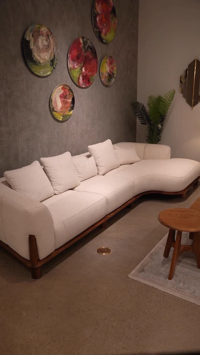 Interior Design Minimalist: 15 Ideas for Clean, Simple Spaces 10 White curved sofa and wooden table on a spacious grey concrete floor