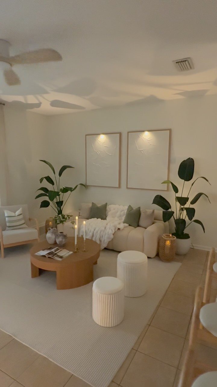Interior Design Minimalist: 15 Ideas for Clean, Simple Spaces 5 Minimalist living room with neutral furniture, potted plants, and textured wall art.