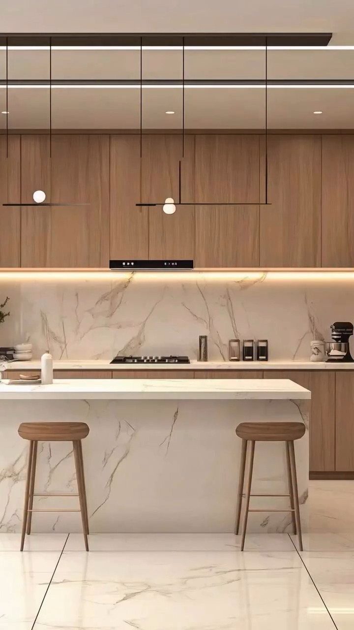 Interior Design Minimalist: 15 Ideas for Clean, Simple Spaces 9 Modern minimalist kitchen with white marble island, light wood cabinets and wooden stools.