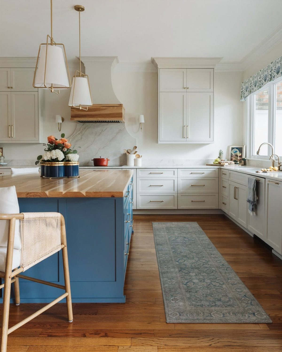White Cabinets: 13 Kitchen Remodel Ideas 8 Blue kitchen island with wood top and white shaker cabinets in bright room