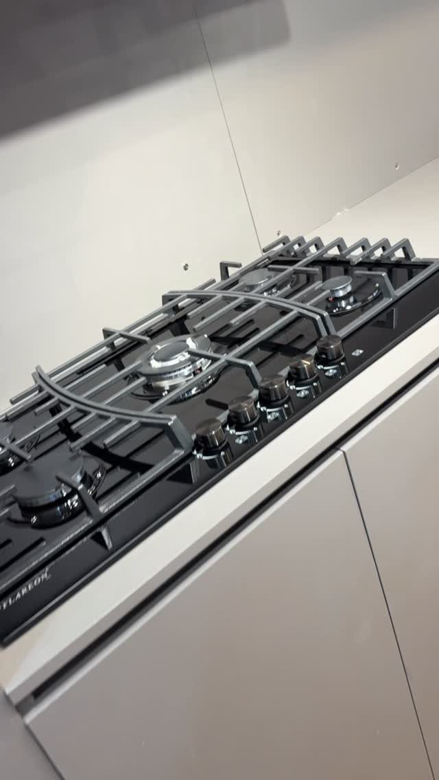 17 Kitchen Stoves Ideas for Every Style and Cooking Need 18 Modern black gas stovetop built into a light grey minimalist kitchen countertop