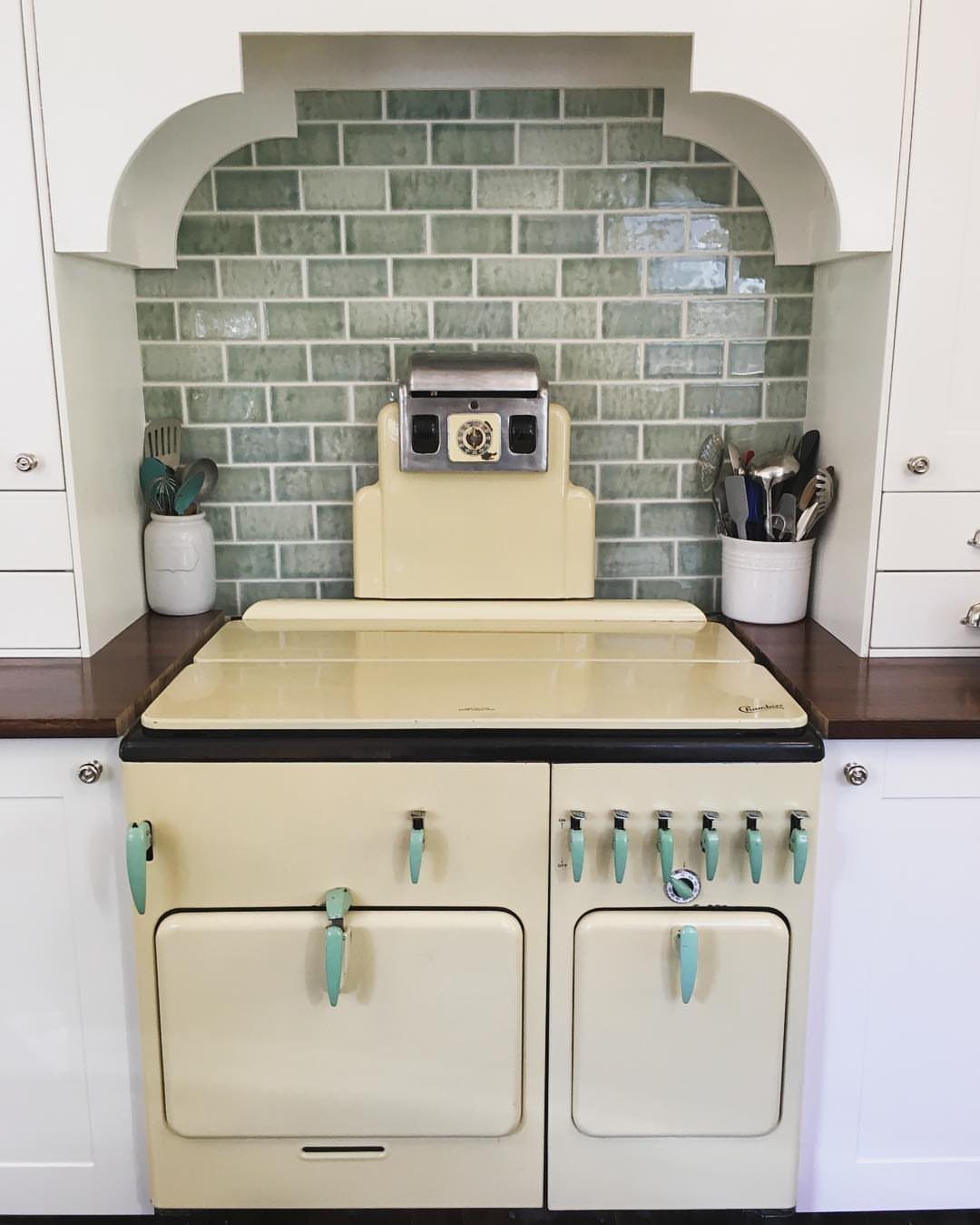 17 Kitchen Stoves Ideas for Every Style and Cooking Need 14 Vintage cream kitchen stove with teal accents and green subway tile backsplash.