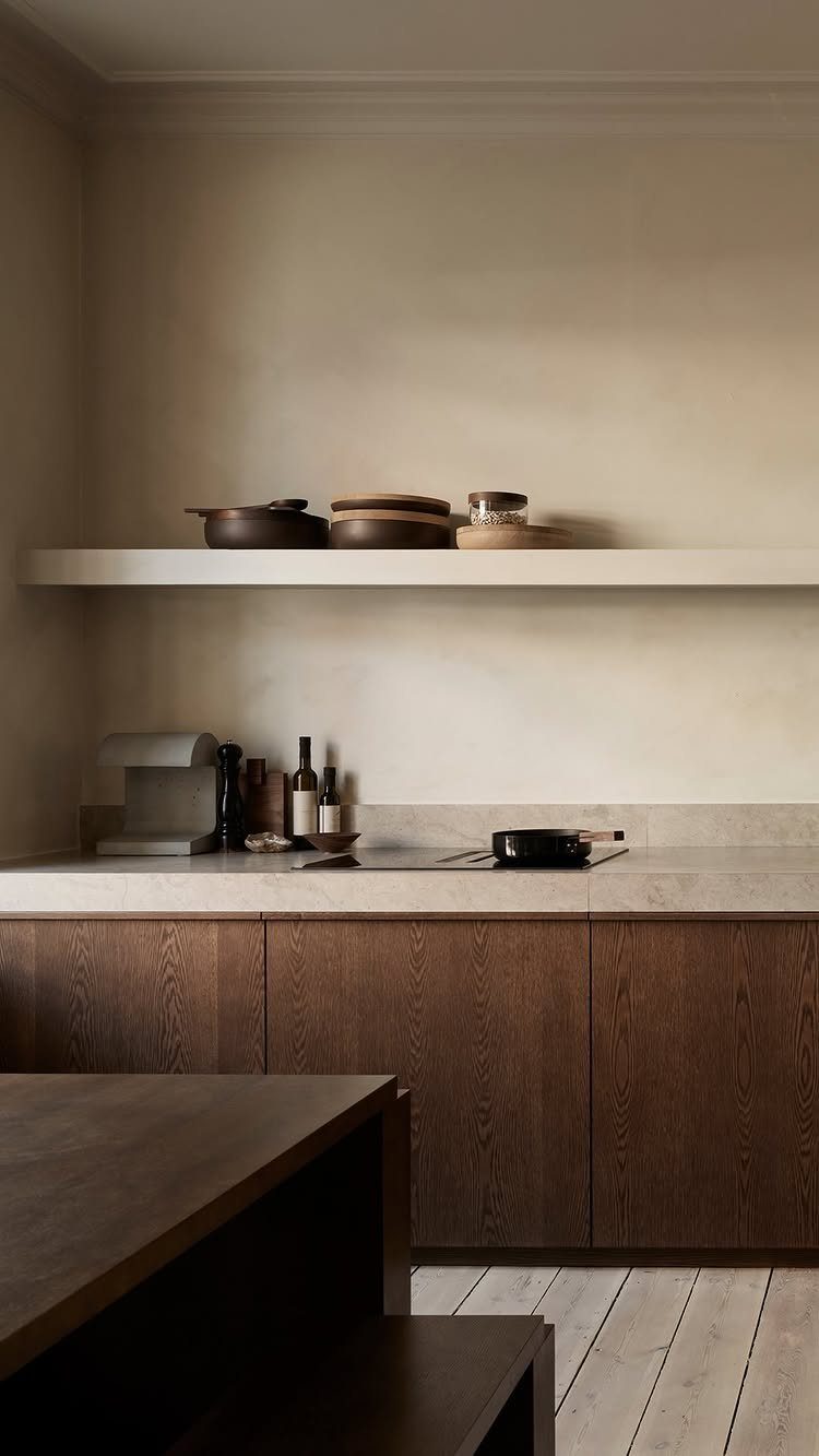 Dark wood cabinets and stone countertops in a minimalist modern kitchen setting