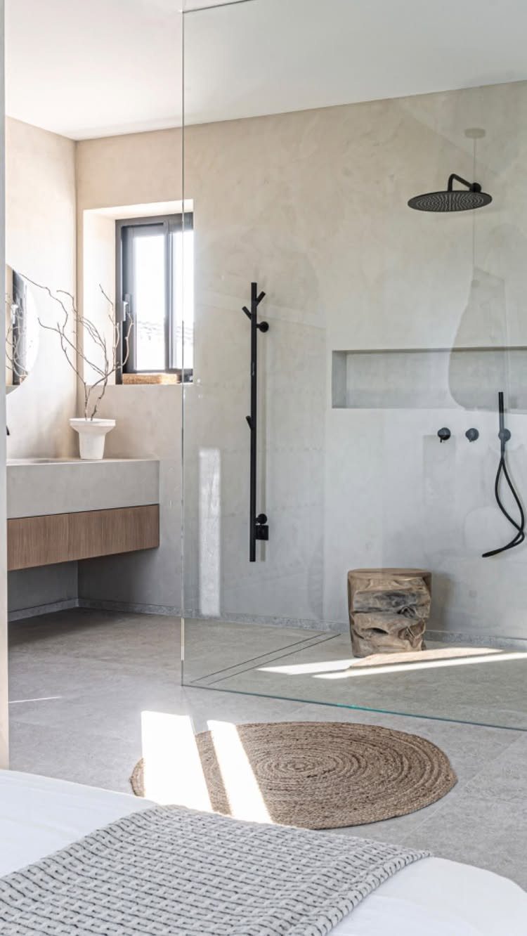 15 Modern Minimalist Home Ideas That Define Clean Living 3 Minimalist bathroom with concrete walls, wooden vanity, and a rustic wood stump stool.