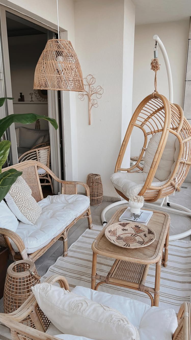 29 Scandinavian Outdoor Furniture for Patios and Gardens 5 Rattan balcony furniture set with a sofa, coffee table, and hanging egg chair.
