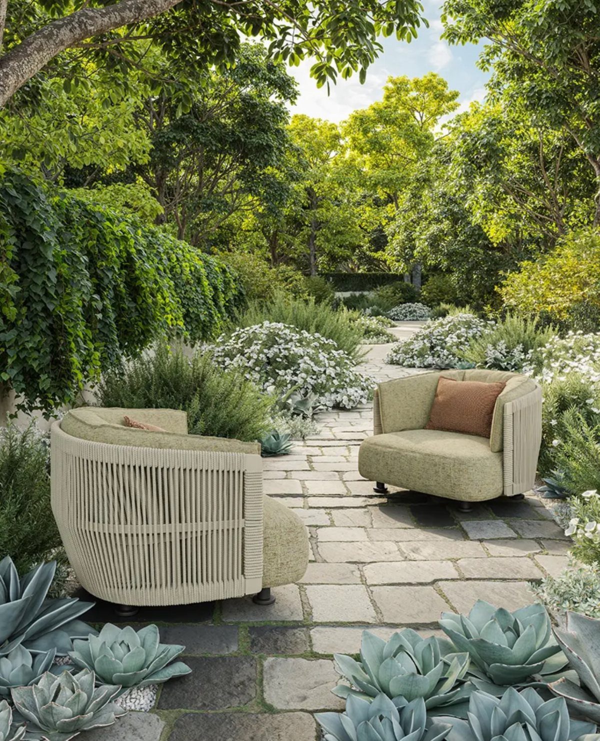 29 Scandinavian Outdoor Furniture for Patios and Gardens 27 Two modern beige woven outdoor armchairs on a stone patio in a lush garden.