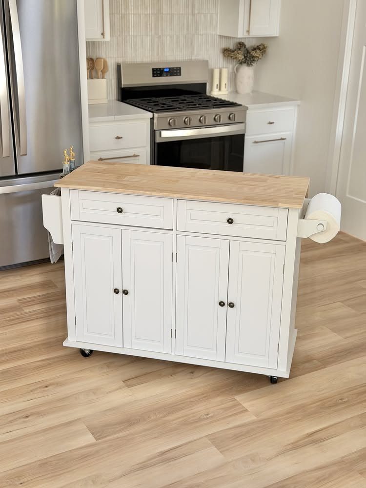 White mobile kitchen island with light wood top in a bright white kitchen