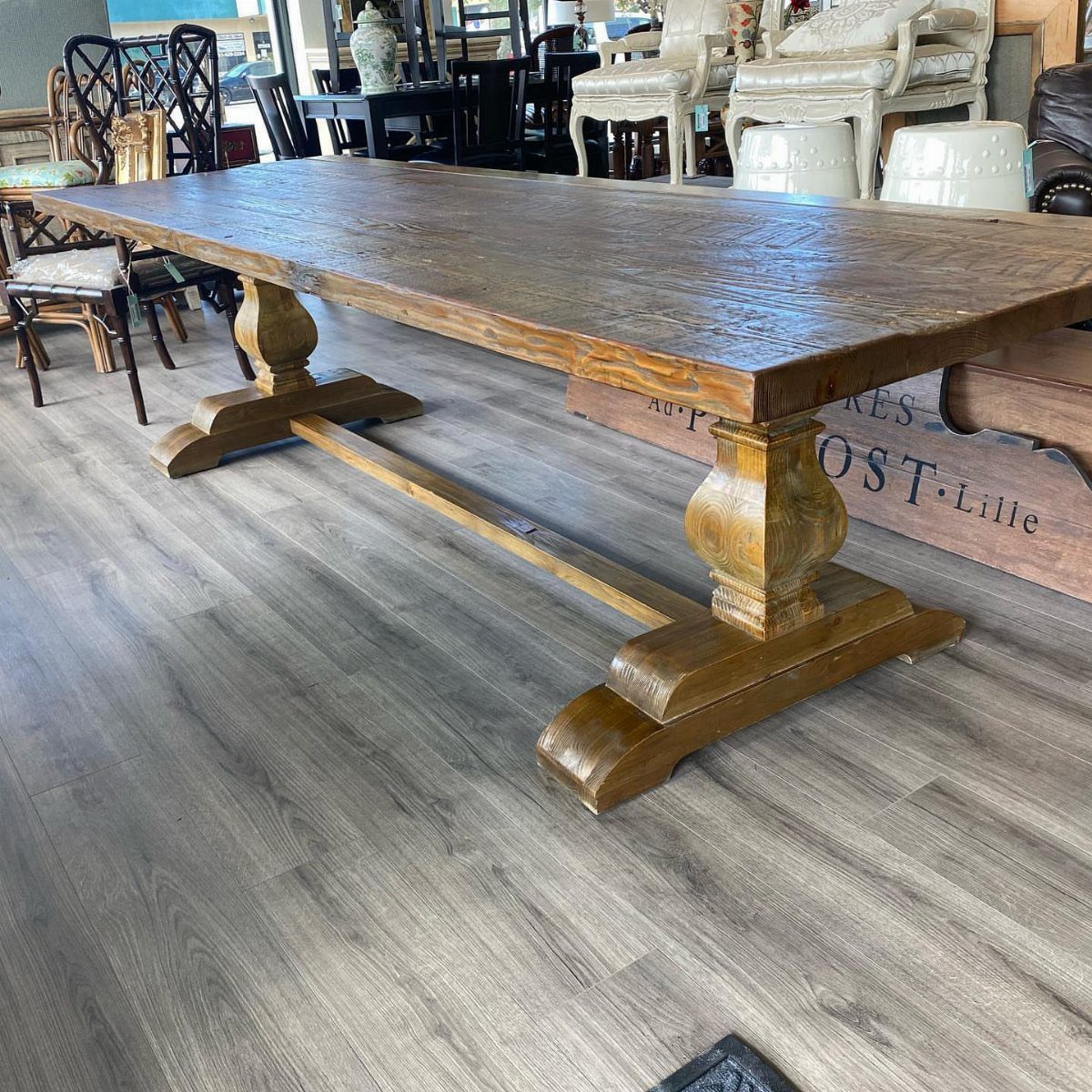 Solid Wood Dining Table Set: 20 Ideas for Your Home 21 Rectangular solid wood dining table with carved pedestal legs in a furniture store