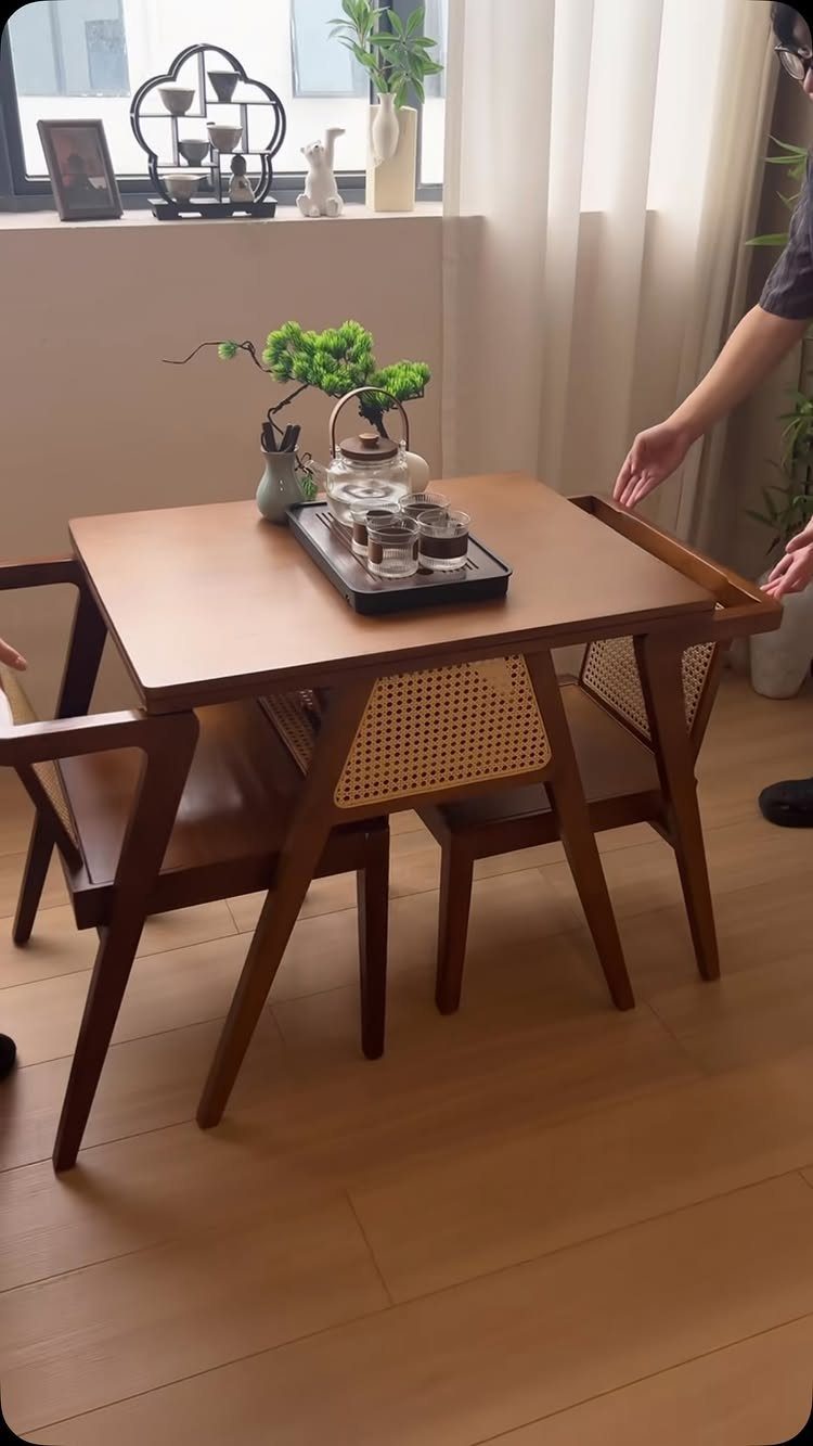 Solid Wood Dining Table Set: 20 Ideas for Your Home 15 Small square wooden dining table and two cane-back chairs in a bright room.