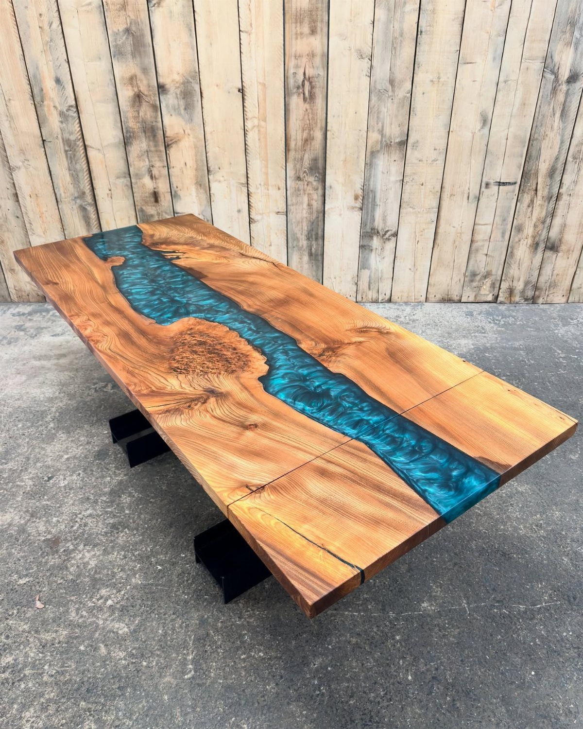 Solid Wood Dining Table Set: 20 Ideas for Your Home 6 Rectangular wood dining table with a blue resin river inlay and black metal legs.