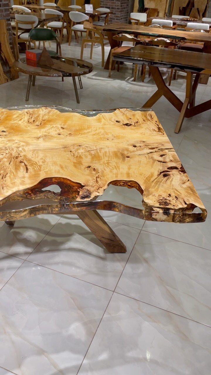 Solid Wood Dining Table Set: 20 Ideas for Your Home 11 Live edge wood table with clear resin river inlay in a showroom