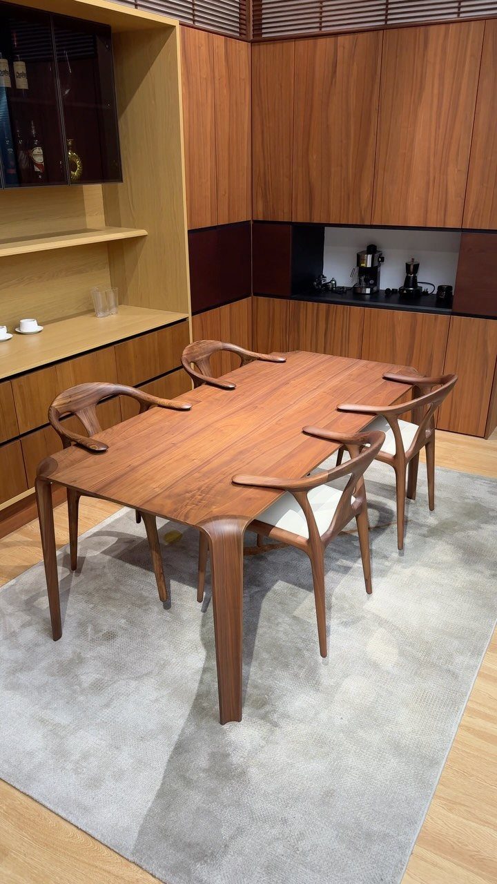 Solid Wood Dining Table Set: 20 Ideas for Your Home 2 Walnut wood dining table and matching curved chairs on a grey area rug.